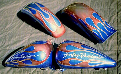 flames and hand lettering on candy blue motorcycle parts