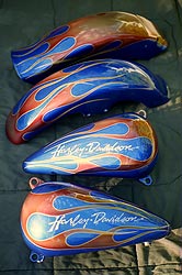 flames and hand lettering on candy blue Hrley Davidson motorcycle parts